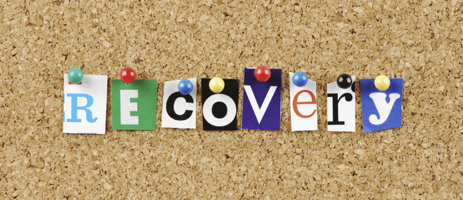The word 'recovery' pinned on a bulletin board.