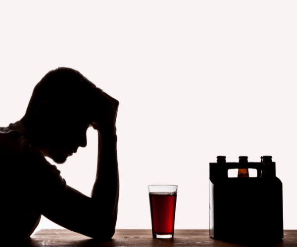 Man staring at his last drink before alcohol detox