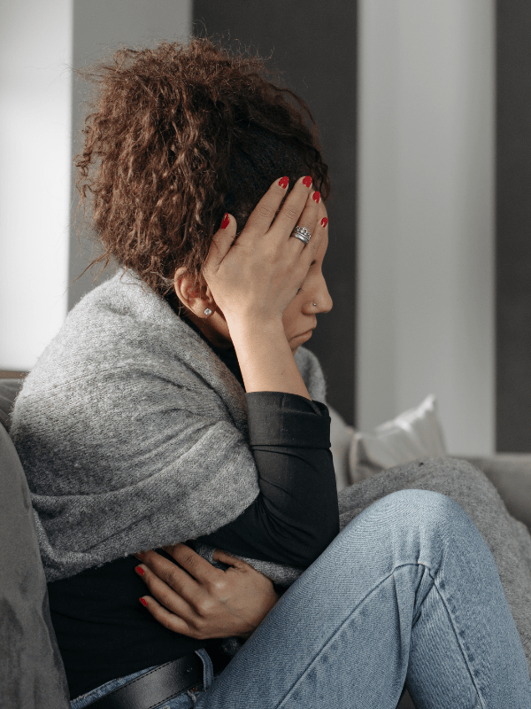 Woman with hand on head with perceived Alcohol withdrawal symptoms