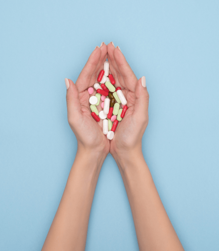 Hands dispensing the necessary vitamins and medication during Drug Rehab