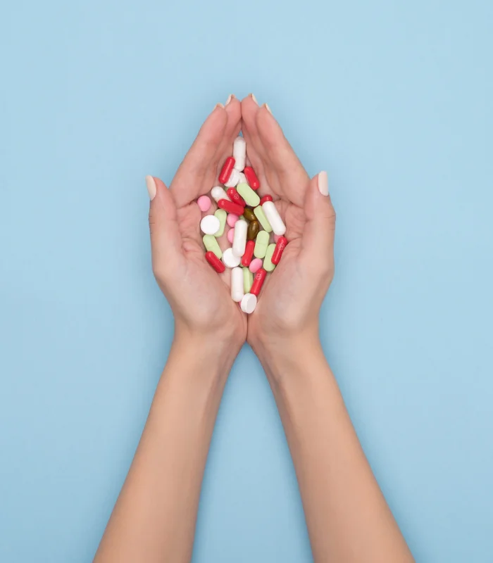 Hands dispensing the necessary vitamins and medication during Drug Rehab