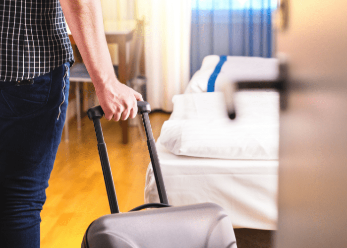 Man pulling suitcase into residential Drug Rehab unit