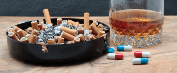 Full ashtray, drink and pills - drug related addictions