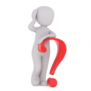 A person standing next to a question mark