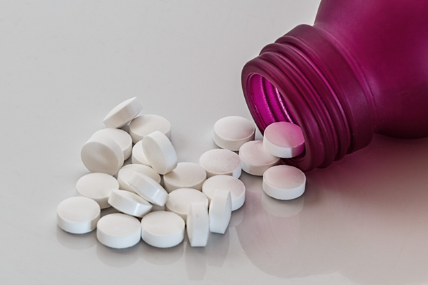 prescription pills fall from a bottle