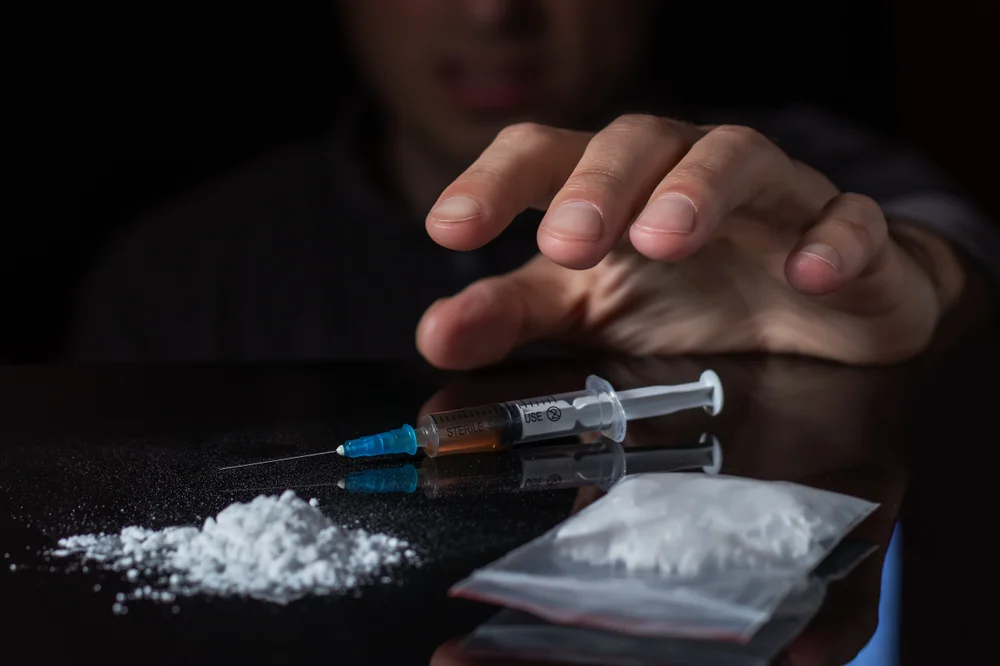 Reaching for drugs on table