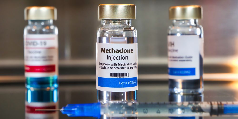 Vial,Of,Methadone,Injection,With,A,Syringe,On,Black,Table Methadone in a bottle ready to be prescribed