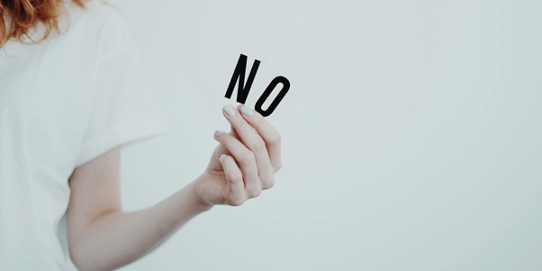 Woman holding no Sign A person holding a sign that says no