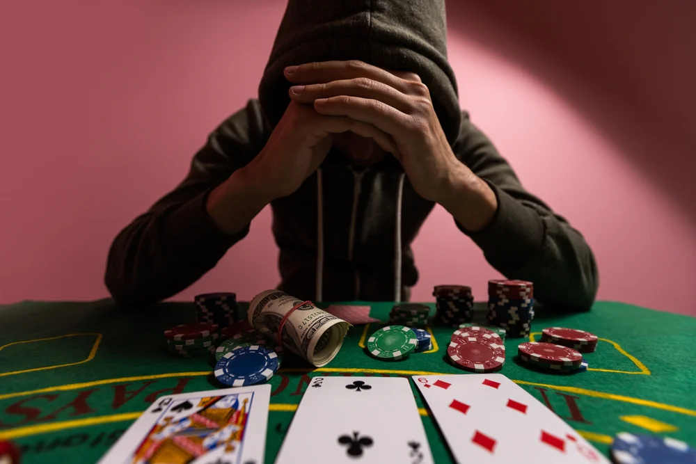 Dangers of gambling shown with an individual struggling