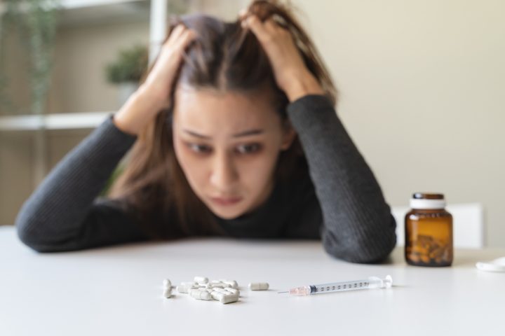 Close,Up,Hand,Of,Young,Women.,Stressed,Female,Taking,Drug Drug Cravings