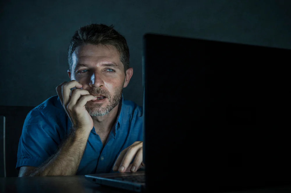 Man watching adult material leading to a porn addiction, clearly showing the symptons of porn addiction