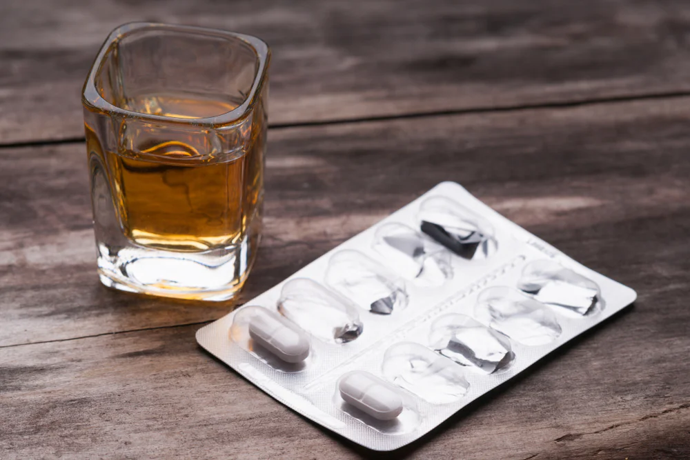 Whiskey,Or,Bourbon,In,A,Shot,Glass,And,Pack,Of Antibiotics with alcohol