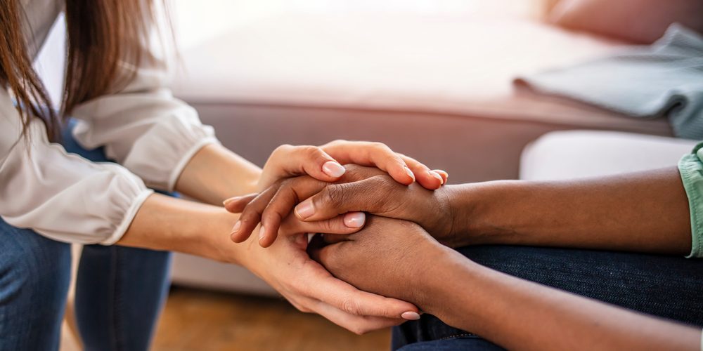 Different,Ethnicity,Female,Friends,Hold,Hands,During,Confidential,Talk,Close Supporting someone with an addiction