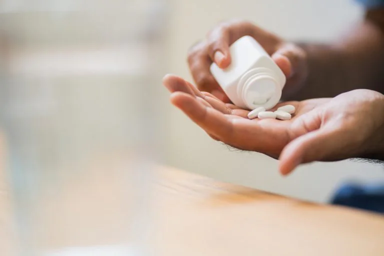 Vicodin being taken from a bottle