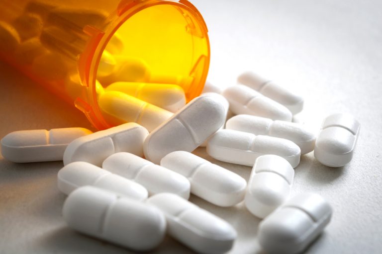 Vicodin pills falling from a bottle