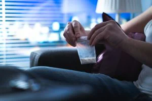 Individual holding a bag of cocaine