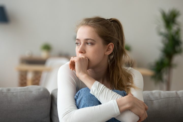 Head,Shot,Woman,Anxious,Worried,Woman,Sitting,On,Couch,At Time to go to rehab.