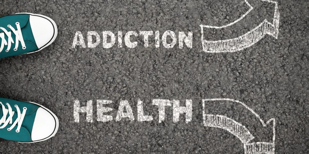 Man,On,Crossroad,Choosing,Addiction,Or,Health,,Thinking,About,Rehab. Person at a cross road with lean addiction