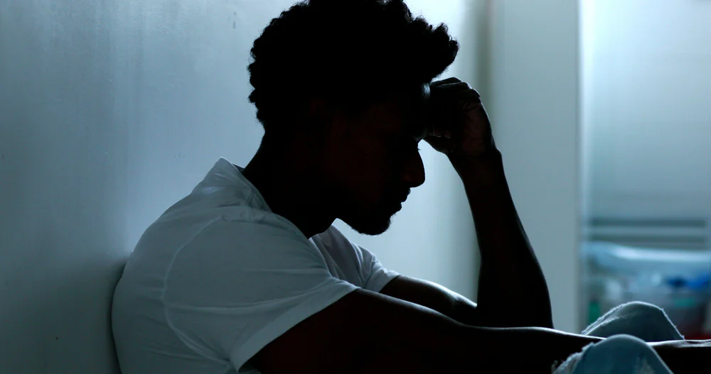 Person,Sitting,On,Floor,With,Mental,Illness Person suffering from cannabis withdrawal