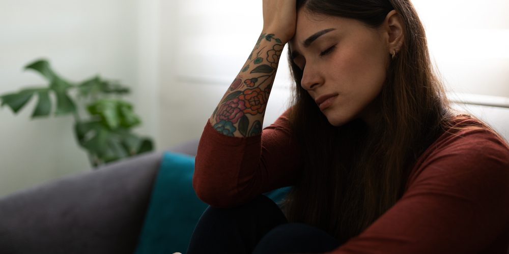 Profile,Of,An,Unhappy,Hispanic,Young,Woman,Sitting,In,His MDMA comedown