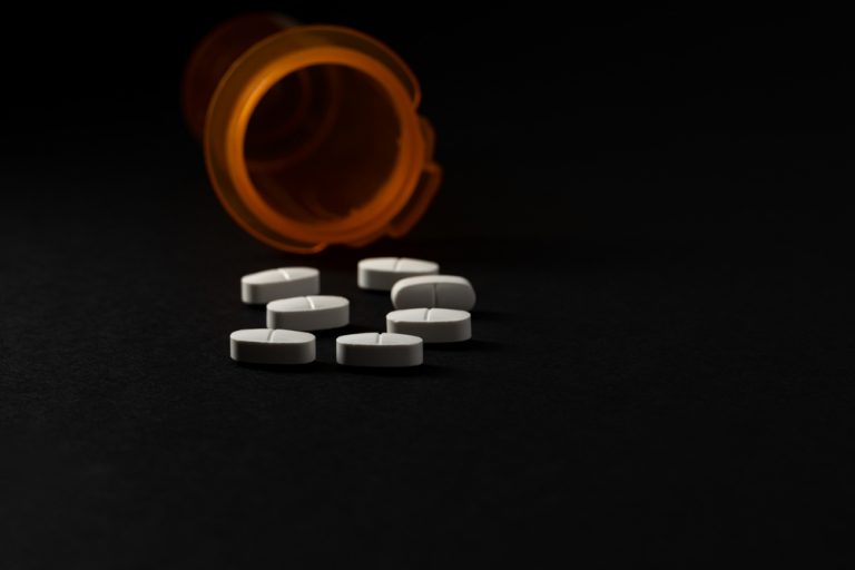 Opoids falling from a bottle