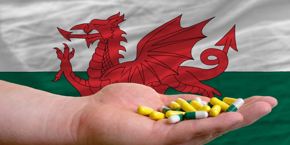 Welsh Flag with bromazolam in someones hand in front