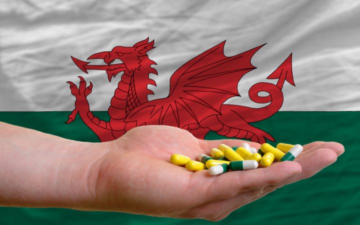 Welsh Flag with bromazolam in someones hand in front