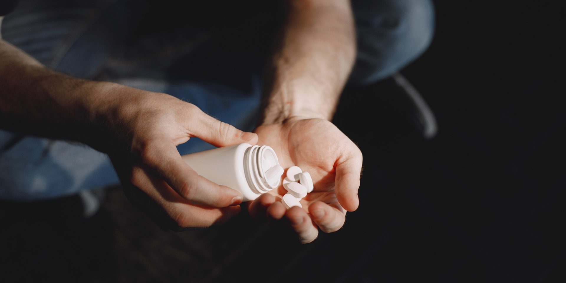 Man,With,Pills,Sitting,On,The,Floor Lorazepam addiction shown through a man